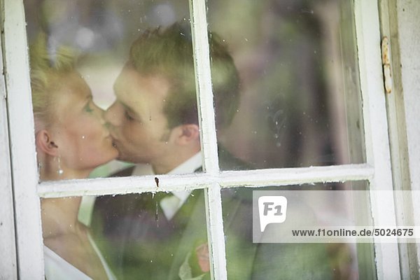 Paar küssen hinter Fenster