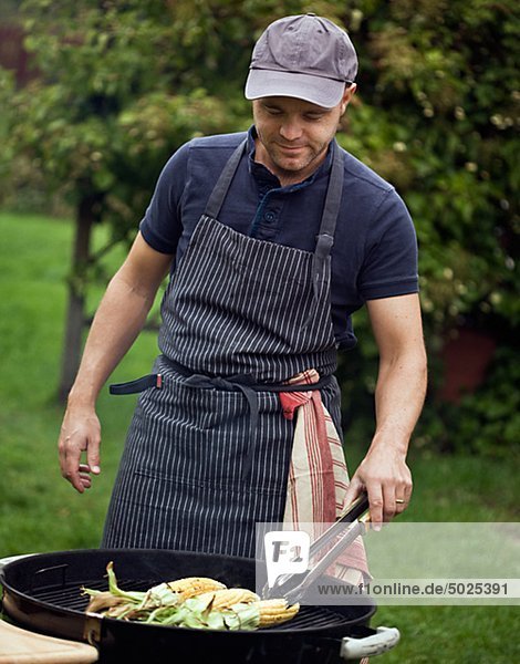 Man with barbecue grill