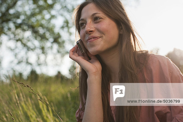 Teenage girl using mobile phone  smiling