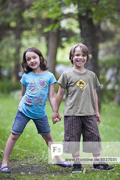 Young boy and girl holding hands. Gimli  Manitoba  Canada.