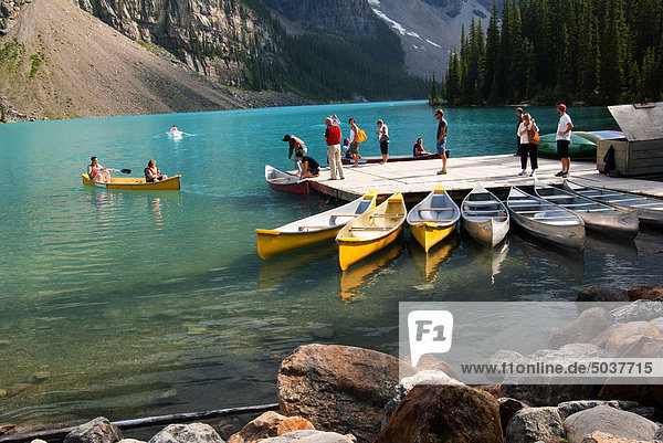 Tourists renting canoes on Moraine Lake in the Valley of the Ten Peaks  Alberta  Canada
