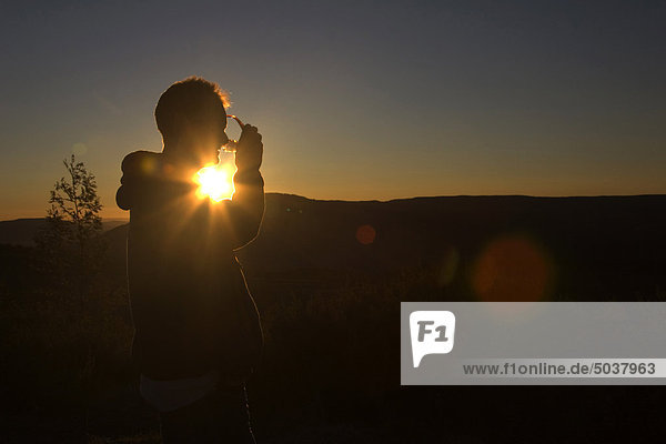 Sunset silhouette of man at Hogsback Mountain  South Africa
