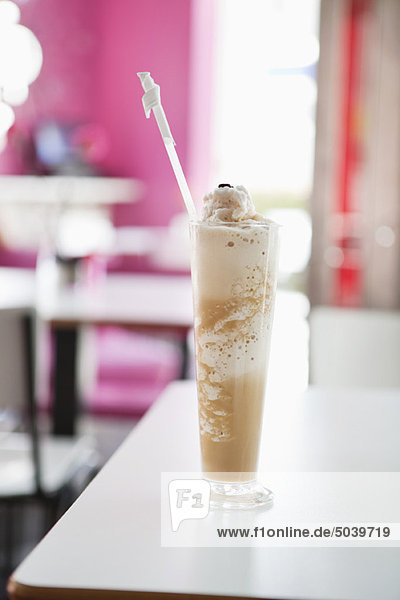 Chocolate milkshake placed on a table in a restaurant