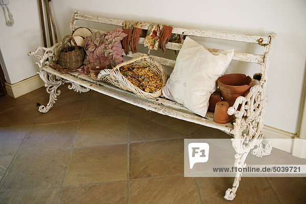 Leaves with flowers and basket on a bench