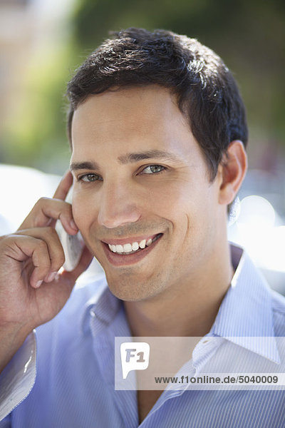 Mid adult man talking on a mobile phone