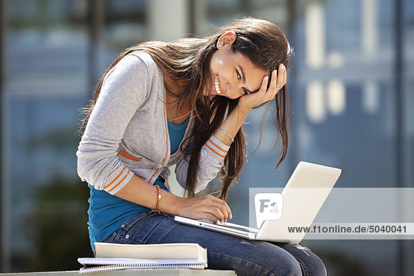 Portrait of a smiling woman using a laptop