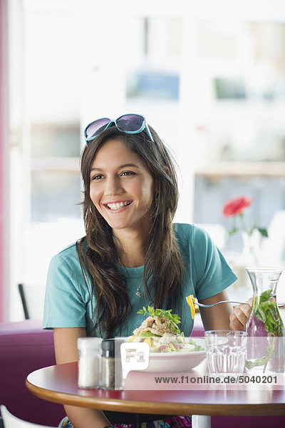 Beautiful woman eating food in a restaurant