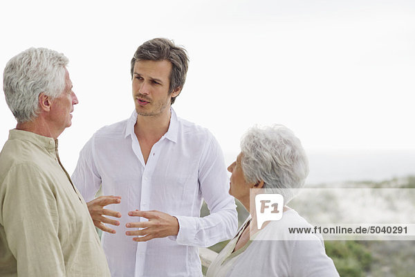 Ein erwachsener Mann  der mit seinen Eltern diskutiert.