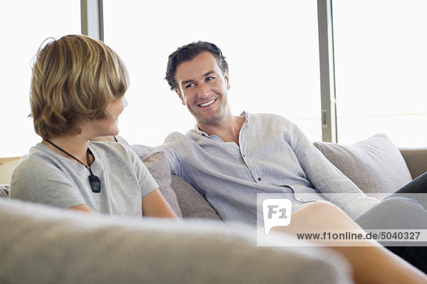 Man talking to his son and smiling