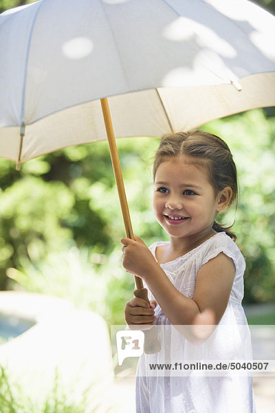 Cute little girl holding an umbrella