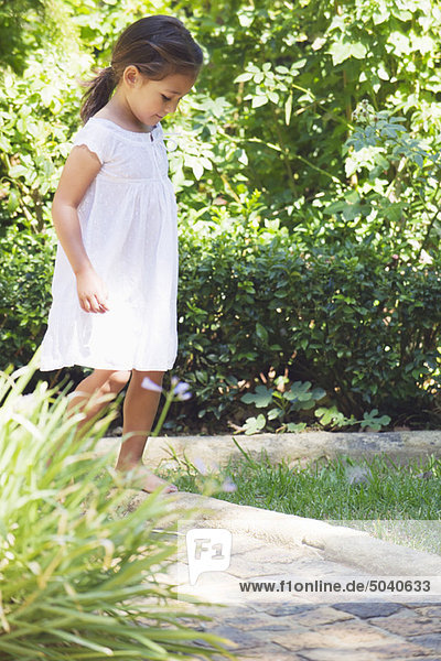 Little girl walking in the garden