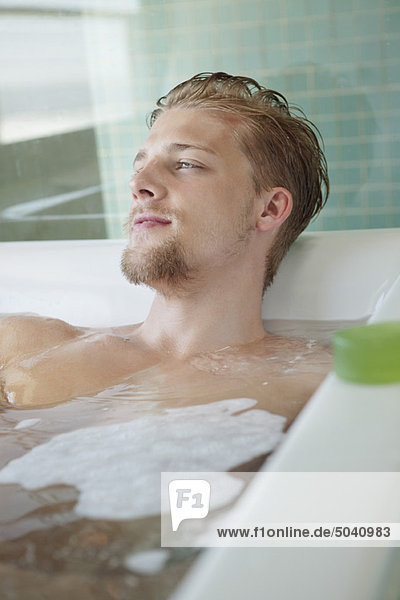 Man relaxing in a bathtub