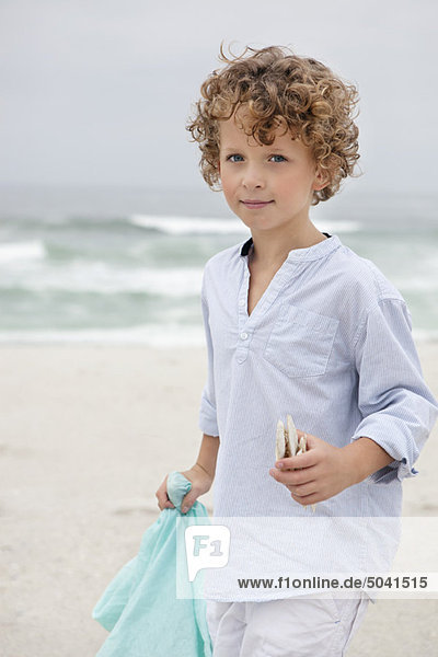 Portrait of a cute boy standing on beach