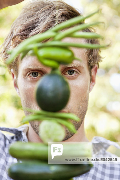Young man holding vegetables