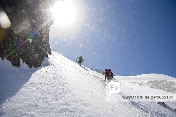 Skiers making their way up the White Pyramid  Mt Chephren  Icefields Parkway  Banff National Park  Alberta  Canada