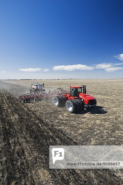 moving tractor and and air till seeder planting wheat  near Dugald  Manitoba  Canada