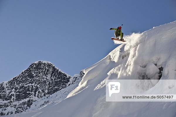 A young man splitboarding in the backcountry of Roger's Pass  Glacier National Park  British Columbia  Canada