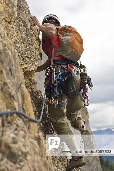 A woman rockclimber climbs Takakaw Falls 5.6  Yoho National Park  British Columbia  Canada