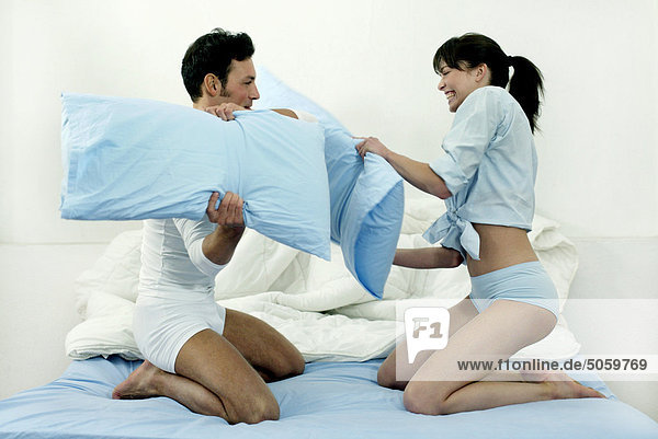Couple playing with pillows
