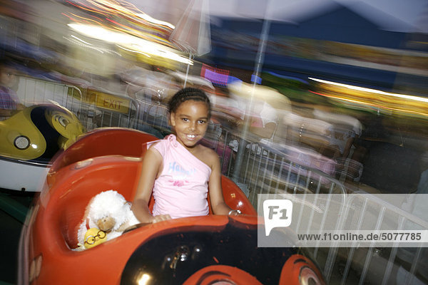 Usa New York Coney Island girl at amusement park on carousel