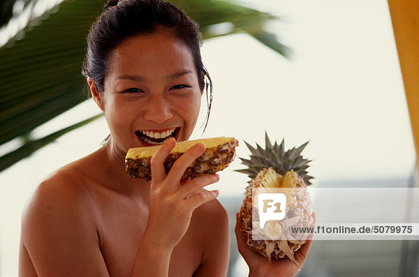 Smiling woman with pineapple