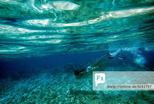 Woman snorkeling in Maldives  underwater view