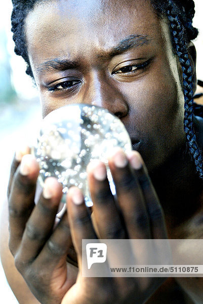 Afro-american man with glass globe