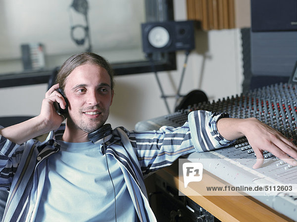 Man at control panel in recording studio