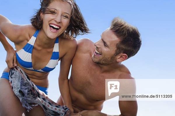 Couple playing on beach together