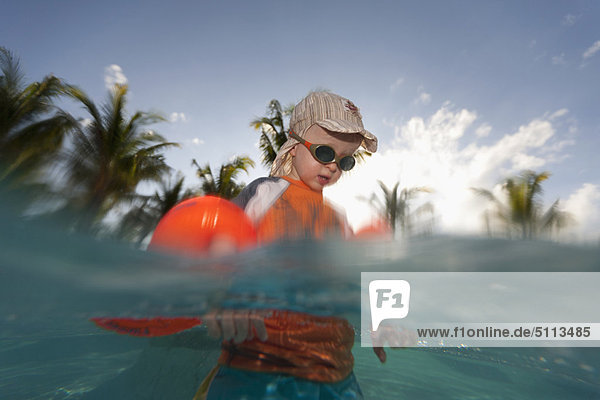 Toddler boy playing in water outdoors