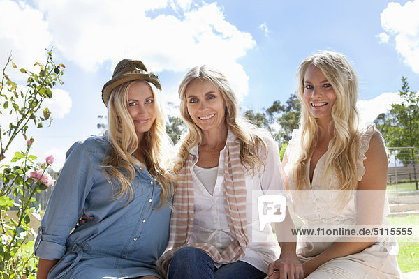 Mother and daughters sitting together
