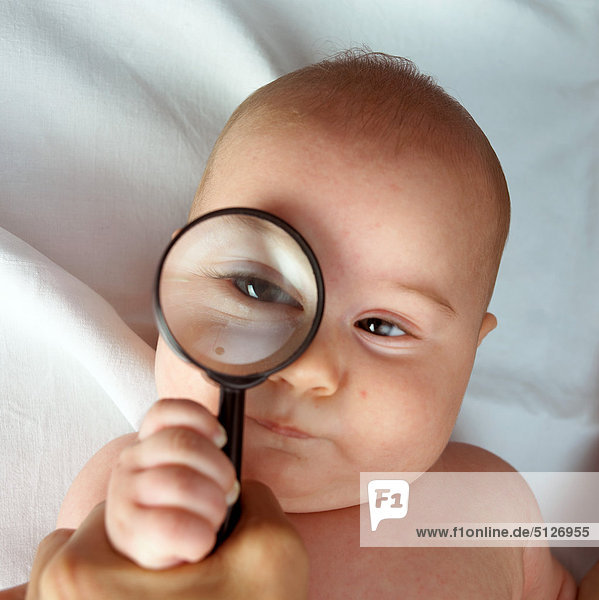 Portrait of a baby looking through lens