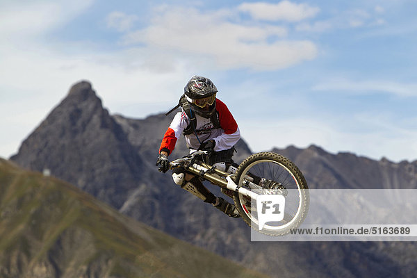 Italy  Livigno  View of man jumping with mountain bike