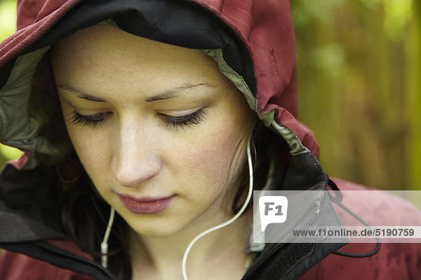 Woman wearing parka and headphones