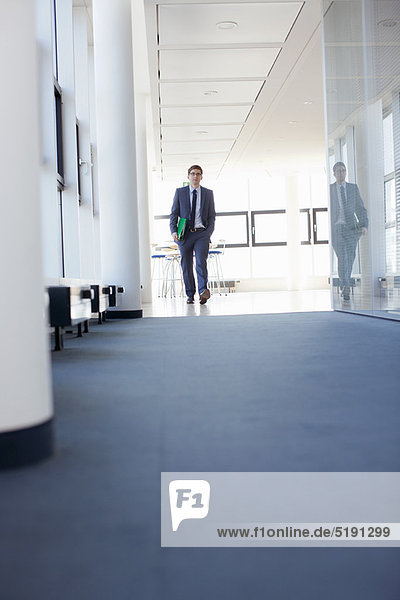 Businessman walking in empty office
