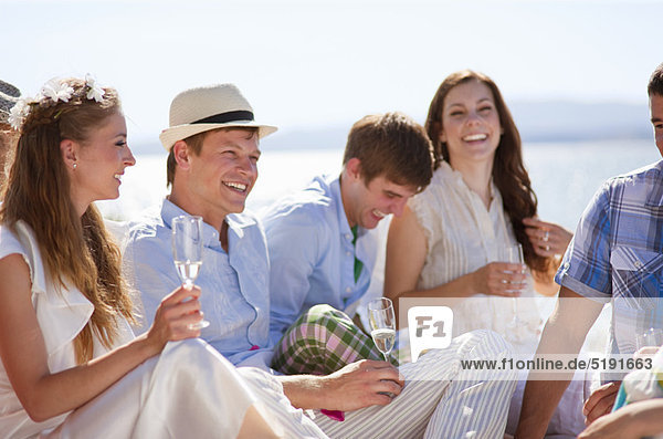 Newlywed couple laughing with friends