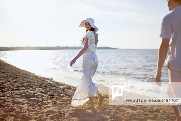 Bride walking on beach