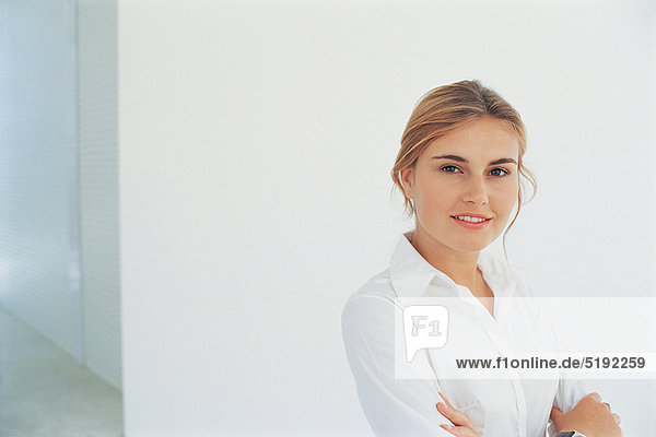 Businesswoman smiling with arms folded