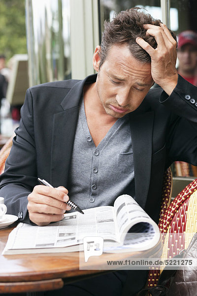 Man reading a magazine looking worried  Paris  Ile-de-France  France