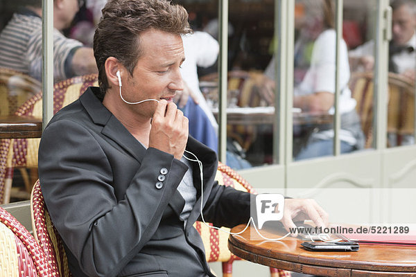 Man talking on a mobile phone in a restaurant  Paris  Ile-de-France  France