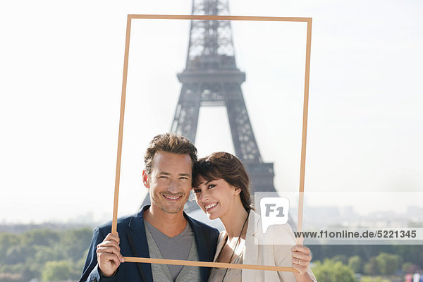 Portrait of a couple framing their dream vacation with Eiffel Tower  Paris  Ile-de-France  France