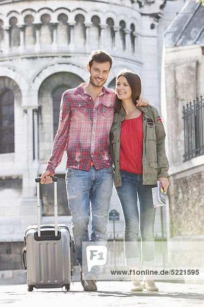 Couple walking on a road with a suitcase  Paris  Ile-de-France  France