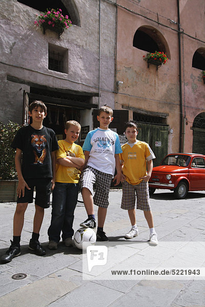 Friends Posing With Football In Street