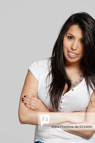 Studio shot of young Chilean woman  arms crossed
