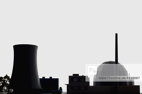 A miniature power station in silhouette