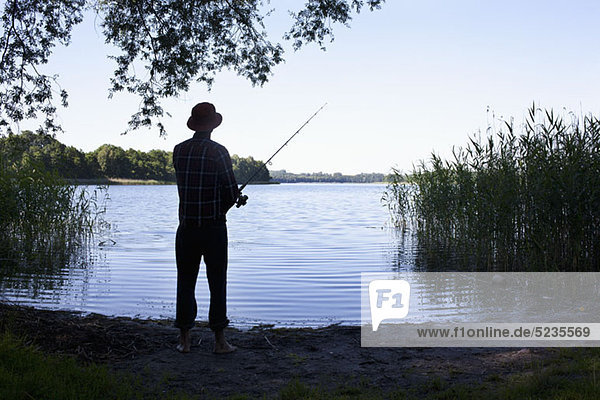 Man fishing by lake