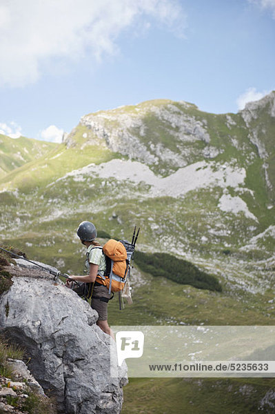 Person climbing rock face at The Wetterstein  Tirol  Austria
