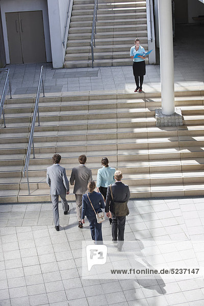 Business people walking on steps