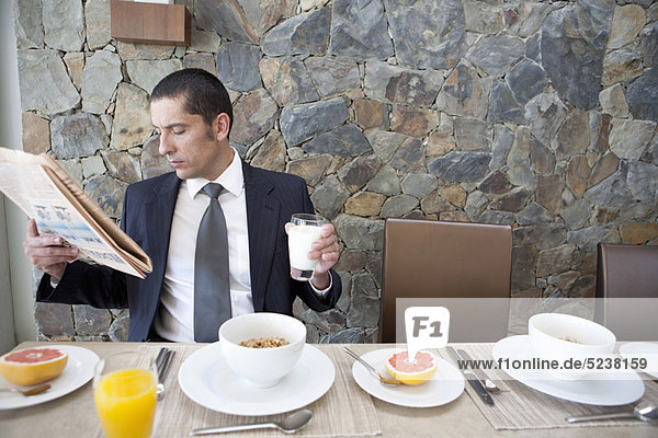 Businessman eating breakfast