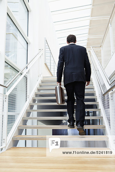 Germany  Bavaria  Diessen am Ammersee  Businesssman walking on staircase with briefcase